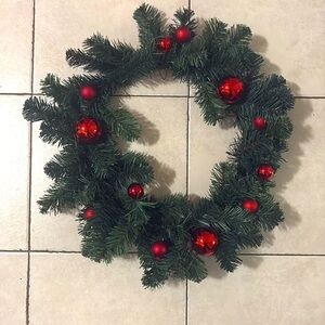 Artificial wreath with red bulbs